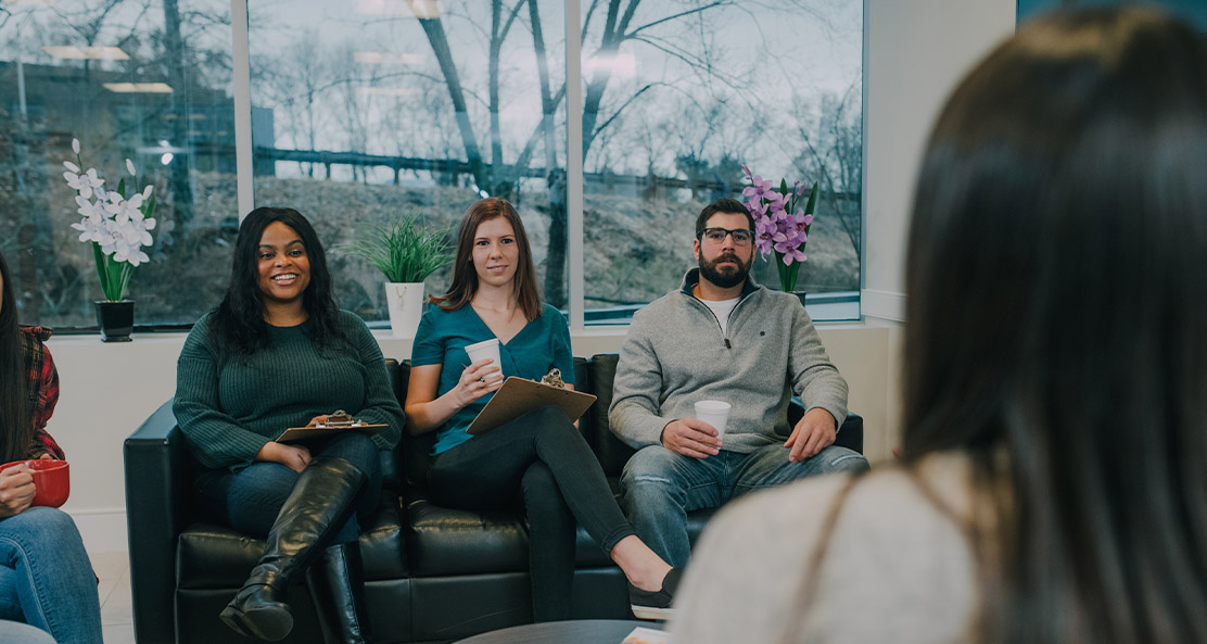 a group of patients chatting in a common area room